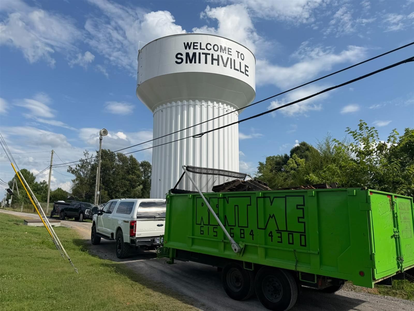 Jameson Services dumpster trailers parked in front of the Smithville, TN water tower