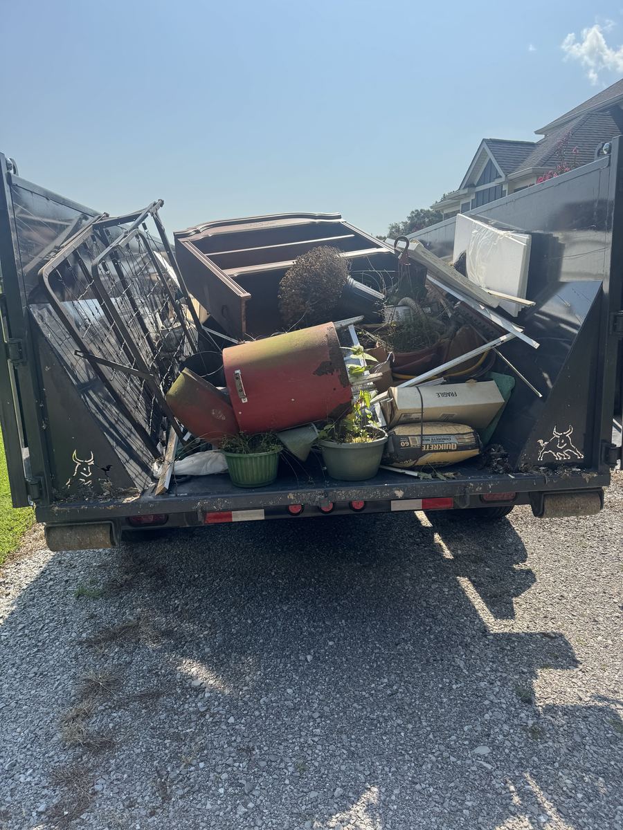 A trailer loaded completely full of junk, showing what counts as a full load