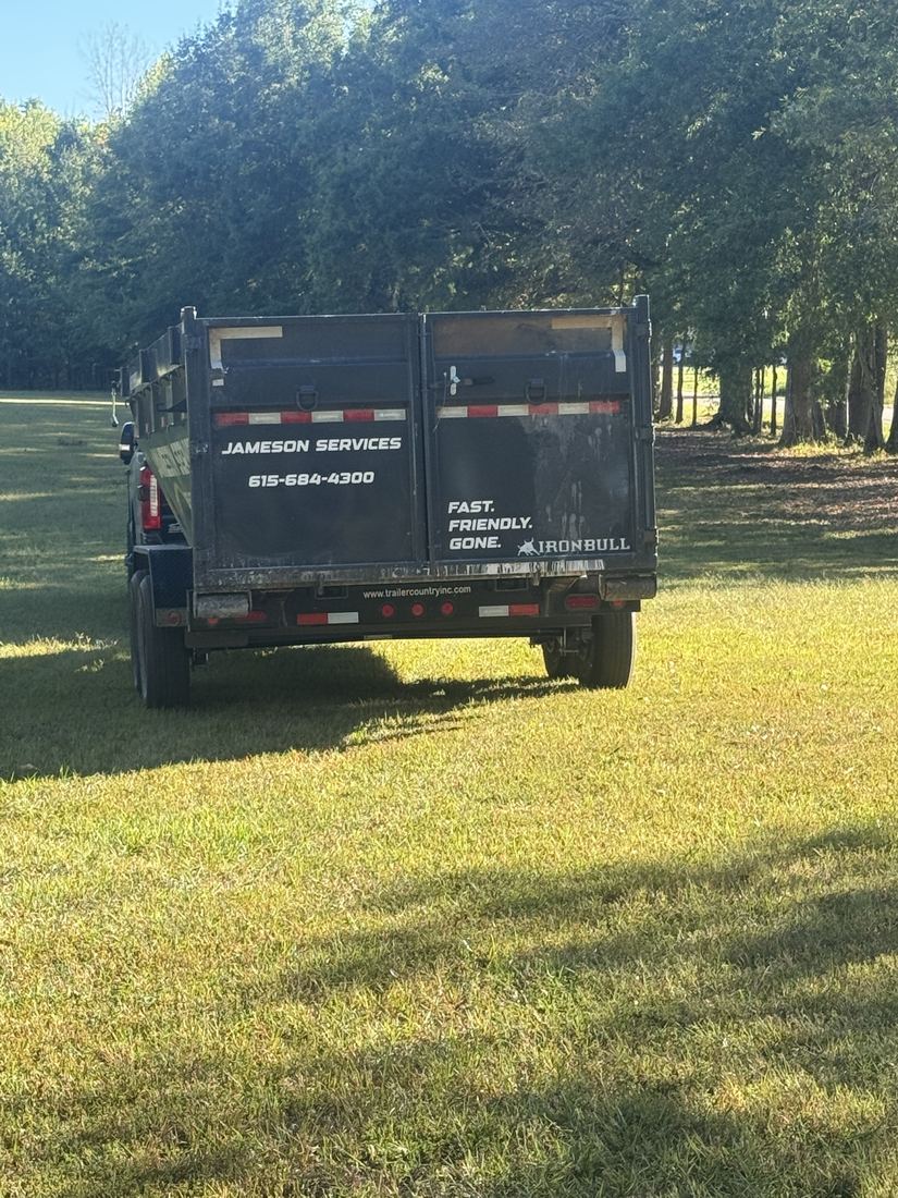 Empty Jameson Services dumpster trailer ready for drop-off